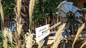 A windmill with a sign that reads 'Adelade Motor Inn.'