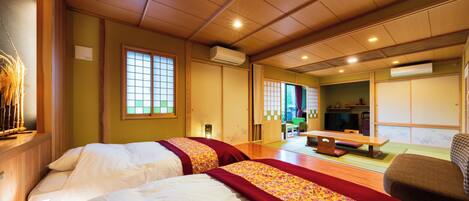 A traditional Japanese-style room with two beds, tatami flooring, and sliding doors.