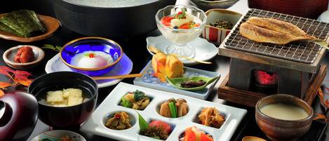 A variety of dishes and a teapot on a table, suggesting a dining setup.
