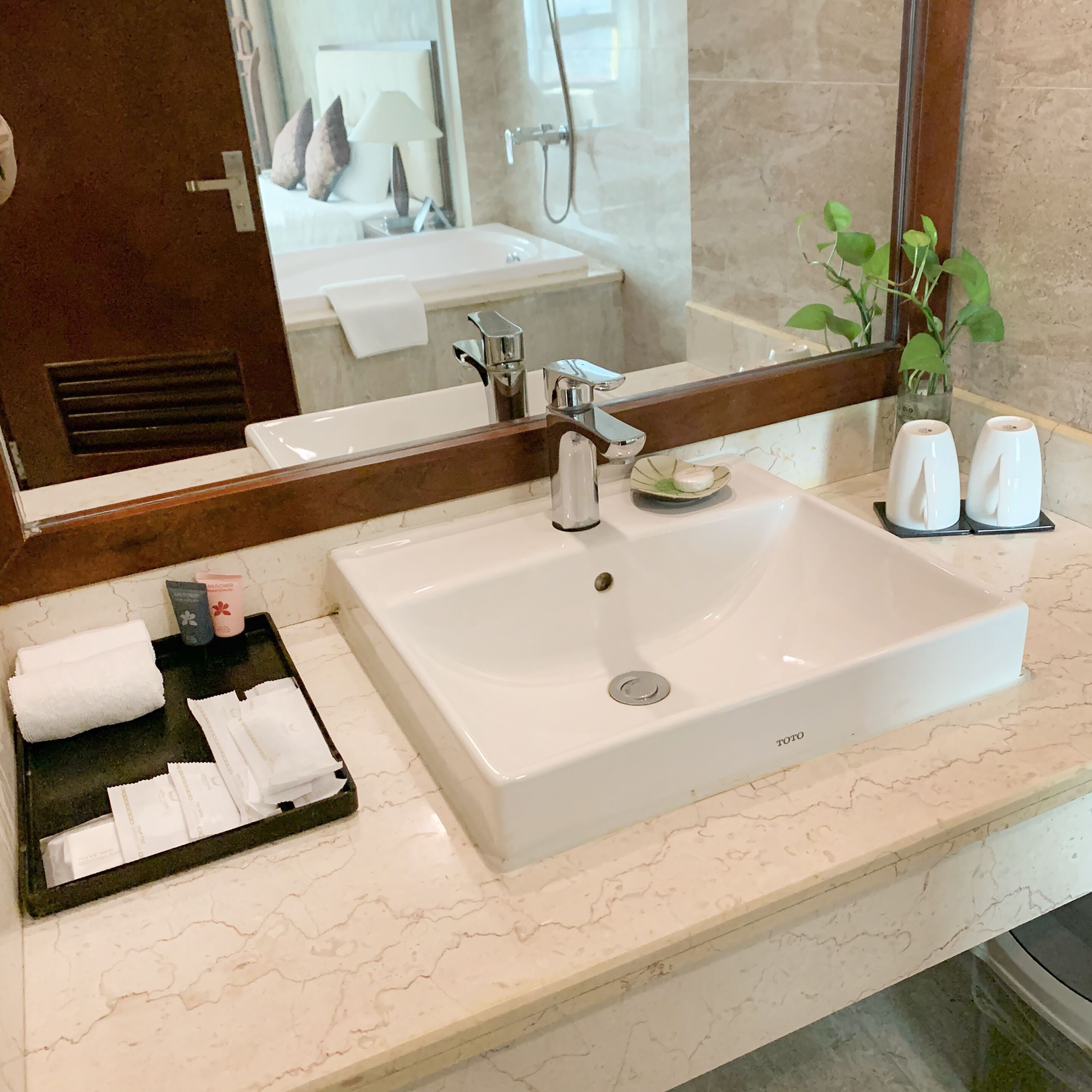 deluxe twin room | bathroom | rainfall showerhead, designer toiletries, hair dryer, towels