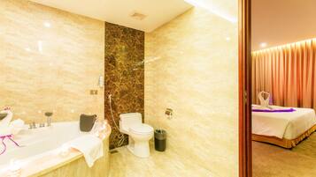 A bathroom with a bathtub, toilet, and shower.