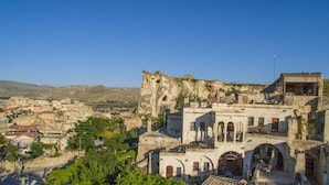 A historic town with ancient stone buildings, including a prominent castle-like structure.