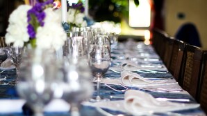 A table set with wine glasses and folded napkins, indicating a formal dining arrangement. - Agriturismo Millefiori Corte delle Rose (Rovigo)