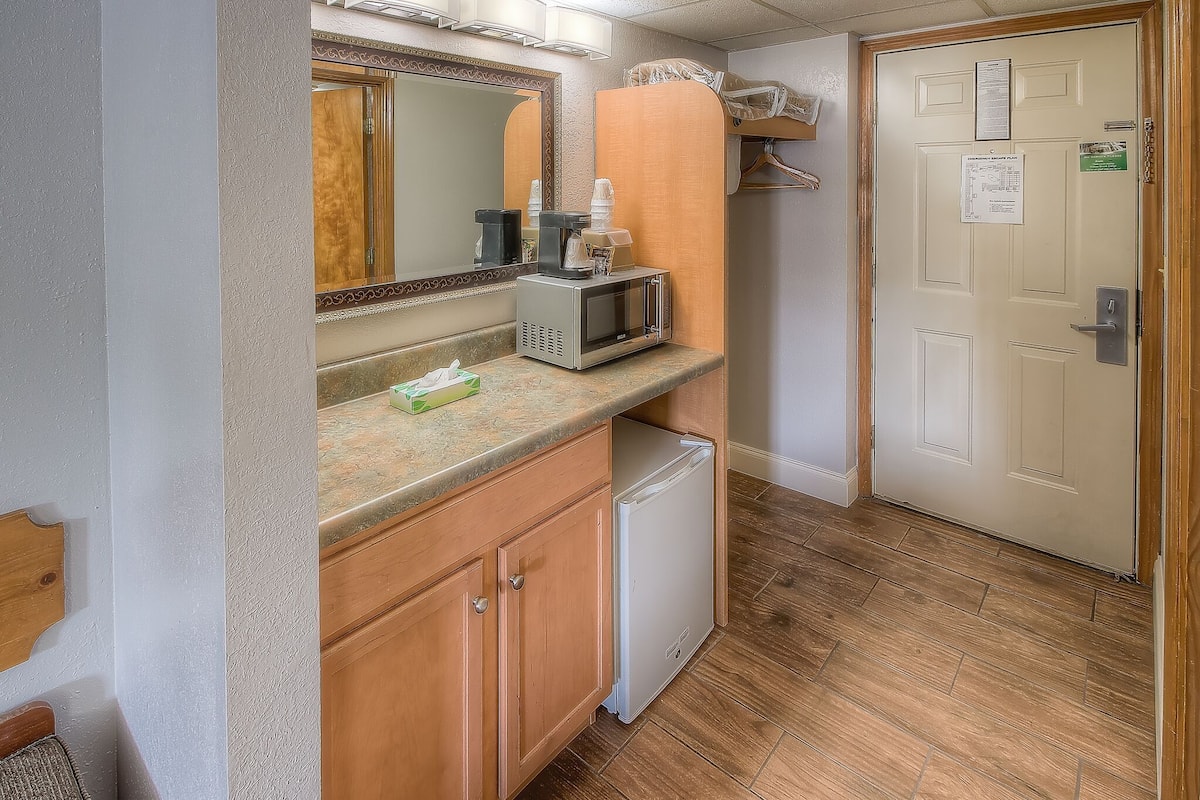 deluxe room, 2 queen beds, pool view | desk, laptop workspace, blackout curtains, iron/ironing board