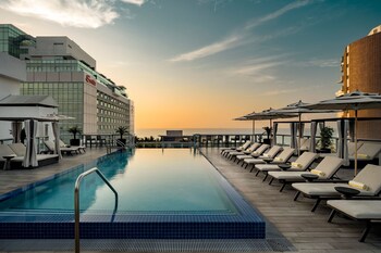 Outdoor pool, cabanas (surcharge), pool umbrellas at AC Hotel by Marriott Miami Beach