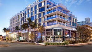 A multi-story hotel with a modern architectural design, featuring balconies, large windows, and a Starbucks coffee shop on the ground floor. - AC Hotel by Marriott Miami Beach (Miami Beach)