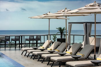 Outdoor pool, cabanas (surcharge), pool umbrellas at AC Hotel by Marriott Miami Beach