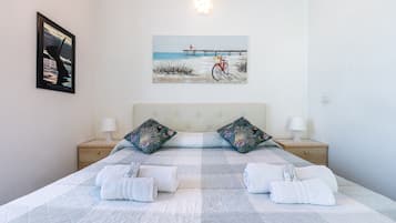 Relax in comfort with a large bed, two bedside tables, and a bicycle nearby.