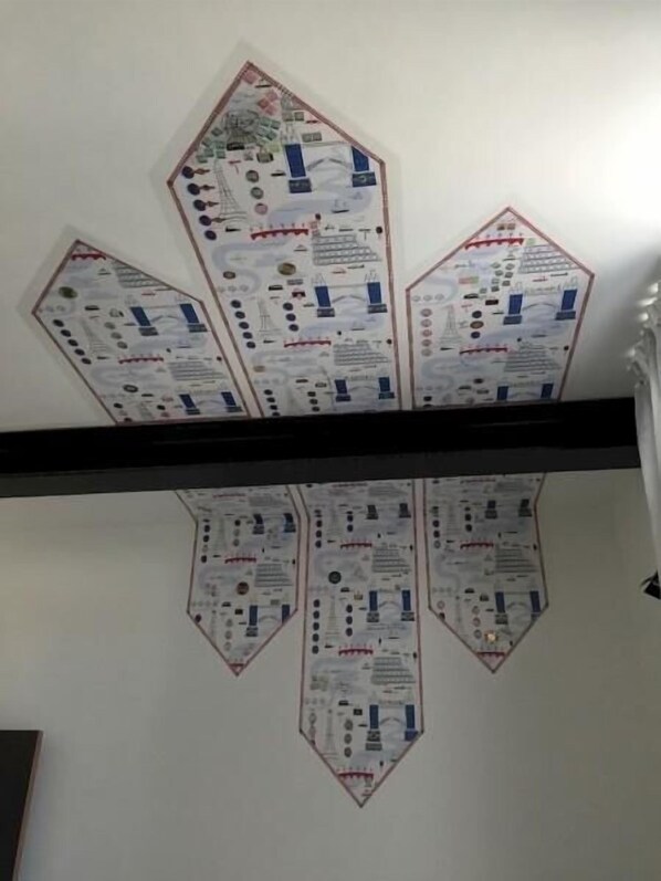 A ceiling with geometric patterns and text, possibly informational or decorative. - Nekotel Concept Art Hotel (Brussels)