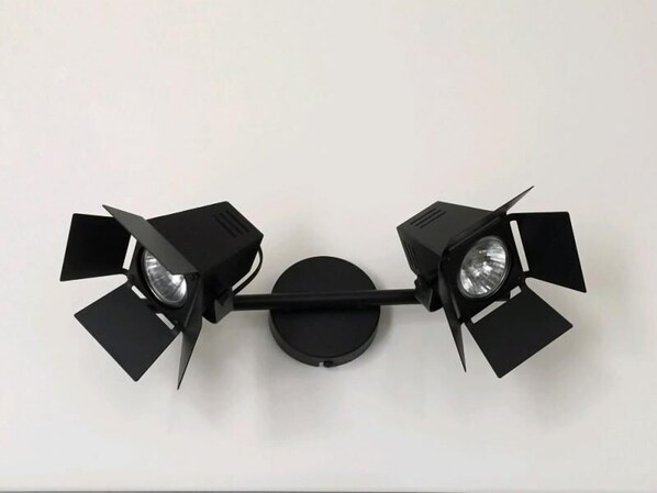 A wall-mounted light fixture with two adjustable arms and a central circular base. - Nekotel Concept Art Hotel (Brussels)
