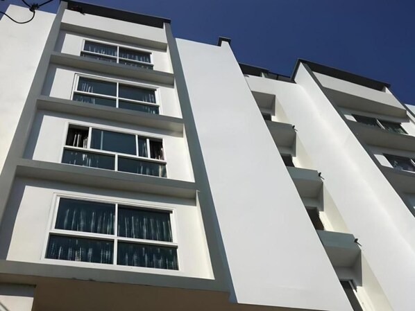 A multi-story building with balconies and windows.
