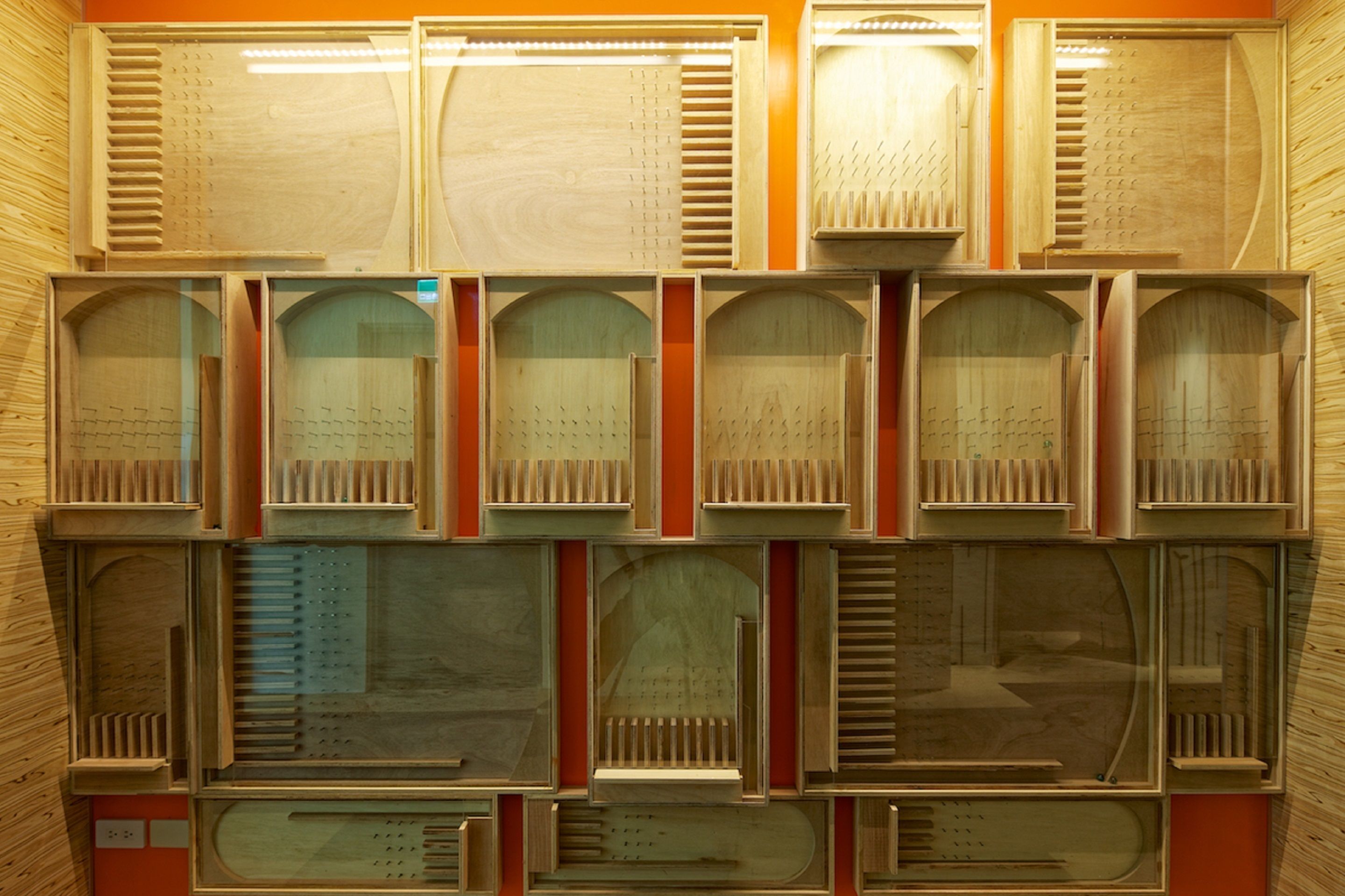 A wall of variously sized and shaped wooden panels, likely part of a building's interior design.