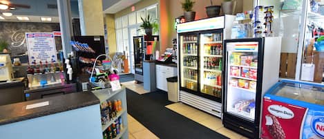 A self-service beverage station with a variety of drinks and a refrigerated display case.