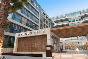 A modern building with a sign reading "HERODS".