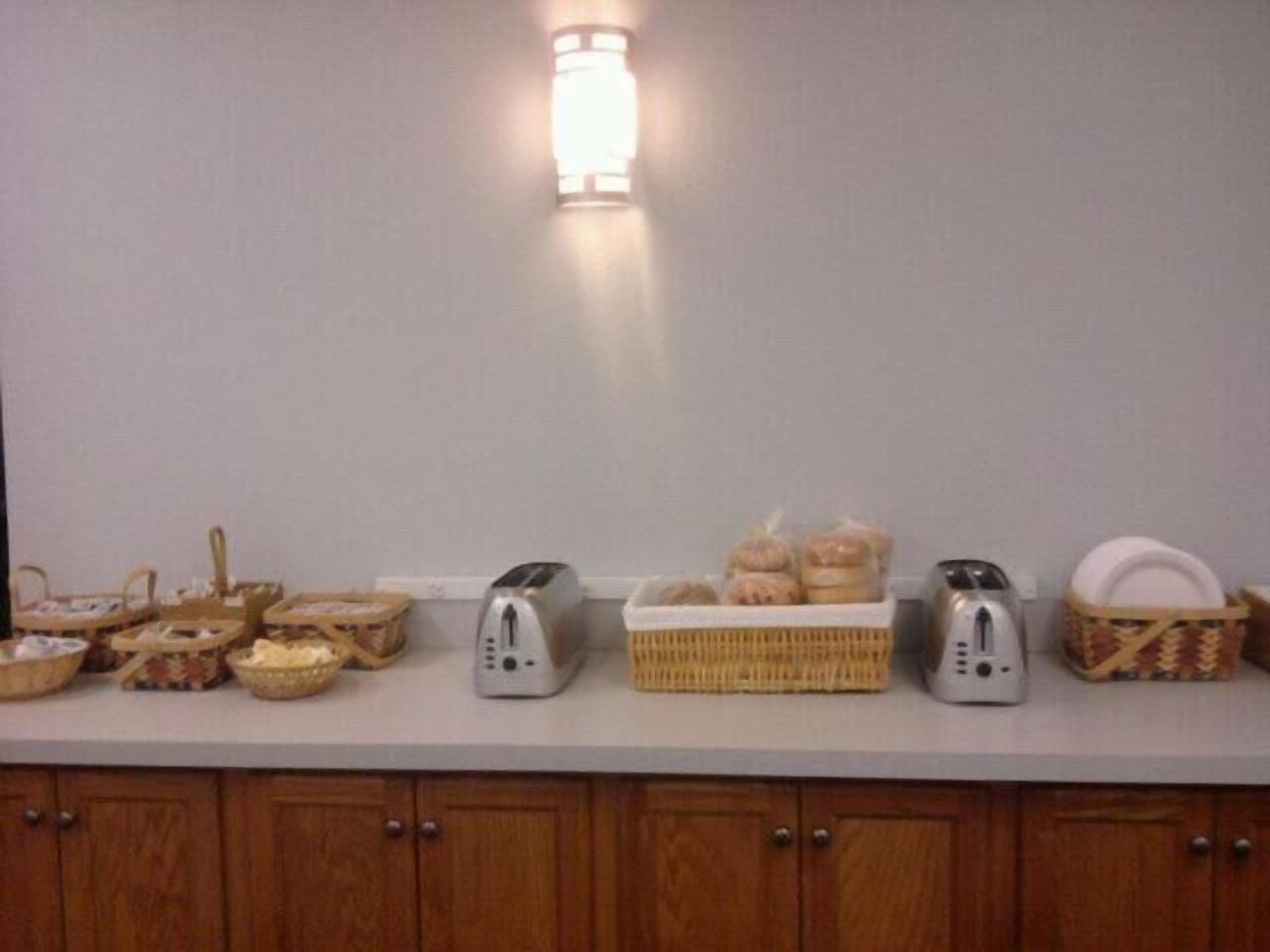 A kitchen counter with various food items and kitchen appliances.