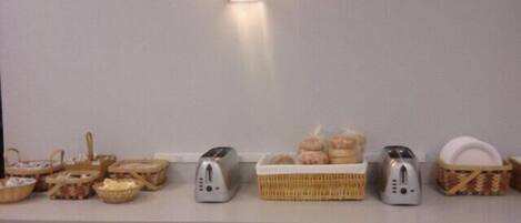 A kitchen counter with various food items and kitchen appliances.