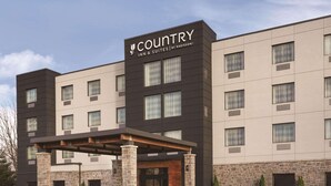 A modern Country Inn & Suites building with a flat roof, multiple windows, and a covered entrance area. - Country Inn & Suites by Radisson, Belleville, ON (Belleville)