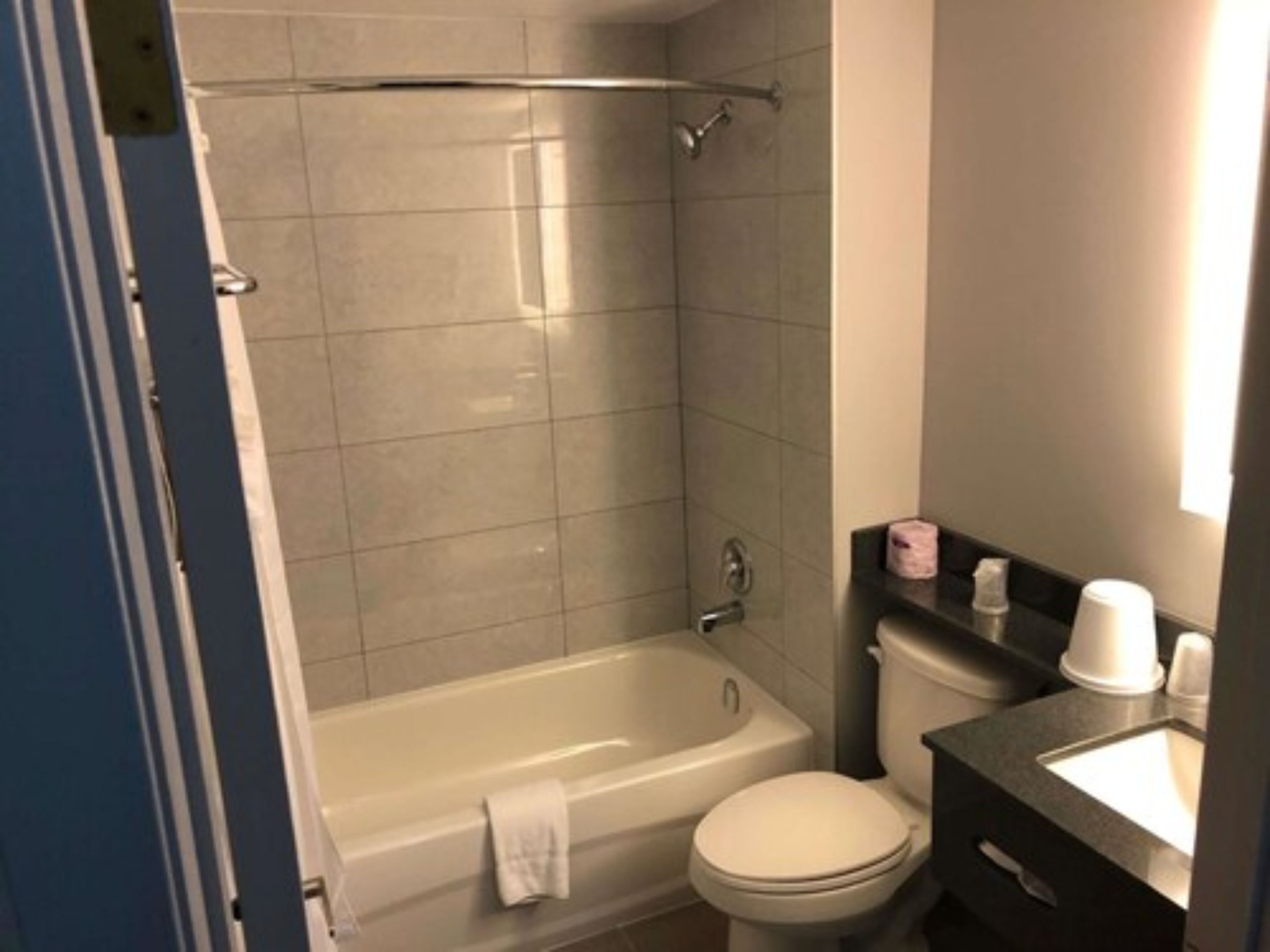 A bathroom with a bathtub, toilet, and sink.