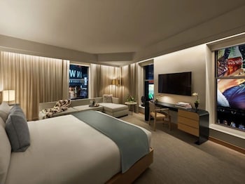 A gym with treadmills, a water dispenser, and a clock on the wall. at The Knickerbocker Hotel