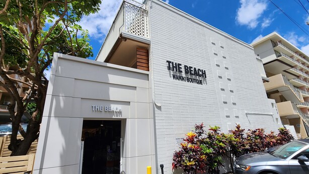 A building with a sign reading "THE BEACH WAIKI BOUTIQUE".