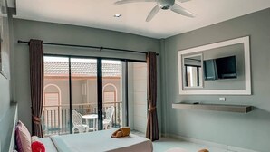 A hotel room with two beds, a ceiling fan, a TV mounted on the wall, and a balcony with outdoor seating. - Bee Orchid Pool Villa (Koh Lan)
