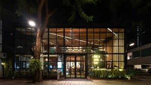 A modern building with a glass facade, a wooden interior, and a sign that reads "Have a good stay." - The Botanic Service Room (Pak Kret)