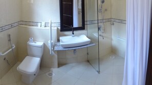 A bathroom with a toilet, sink, and shower. - The Monarch Hotel (Nairobi)