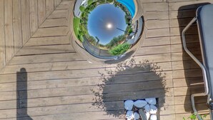 A circular viewing platform with a pool and lounge chairs. - Valentina apartments (Hersonissos)