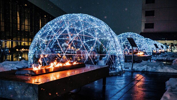 Outdoor seating areas with transparent domes and tables, surrounded by snow. - The Davenport Grand, Autograph Collection (Spokane)