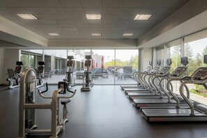 A gym with treadmills, weight machines, and cardio equipment. - The Davenport Grand, Autograph Collection (Spokane)