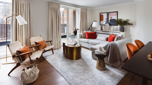 A modern living room with a sofa, chairs, a coffee table, and a dining table. - Native Mayfair (London)