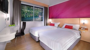 A hotel room with two beds, a desk, a chair, a TV, and a window with curtains. - favehotel Jababeka Cikarang (Cikarang)