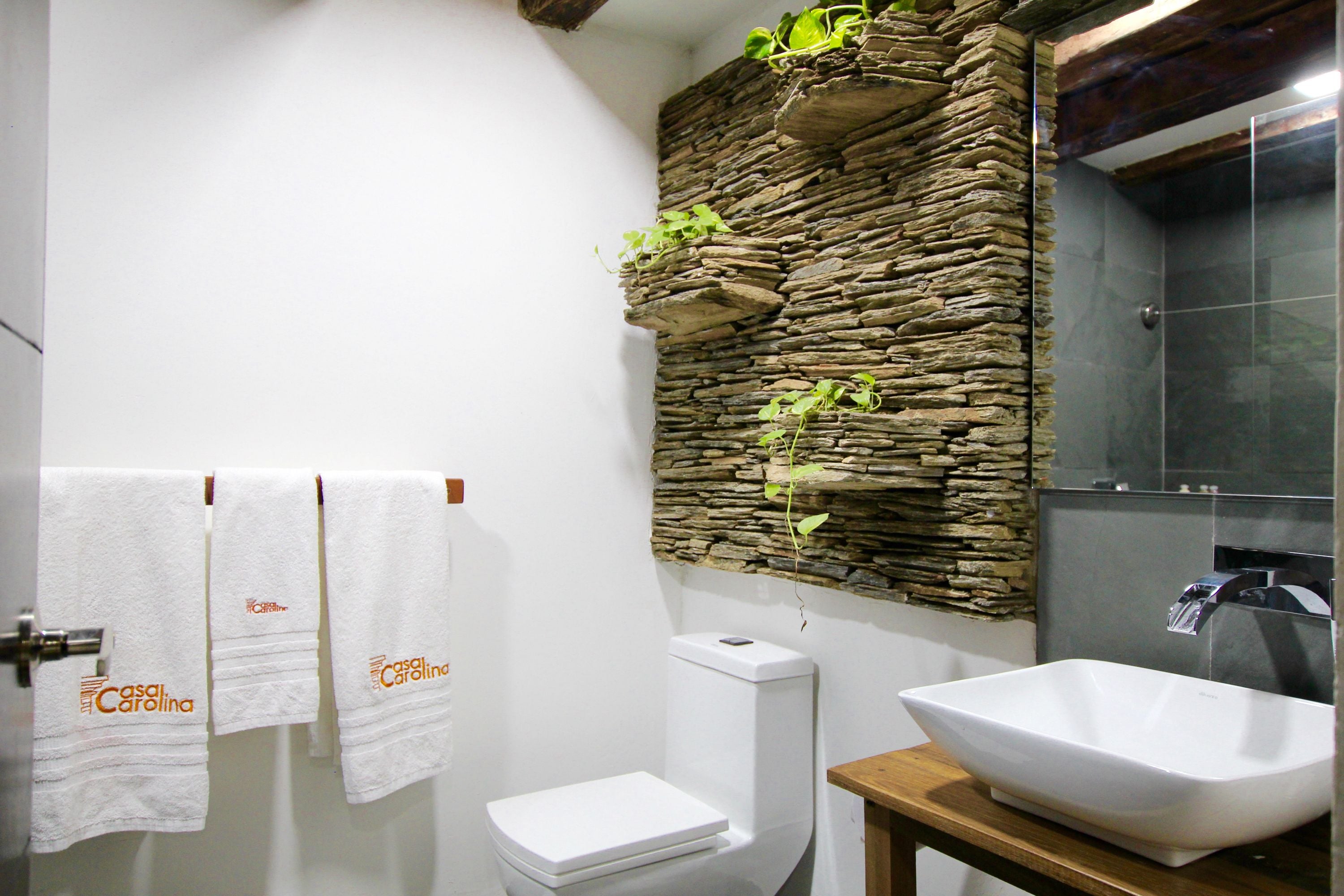 deluxe room | bathroom | shower, rainfall showerhead, designer toiletries, hair dryer