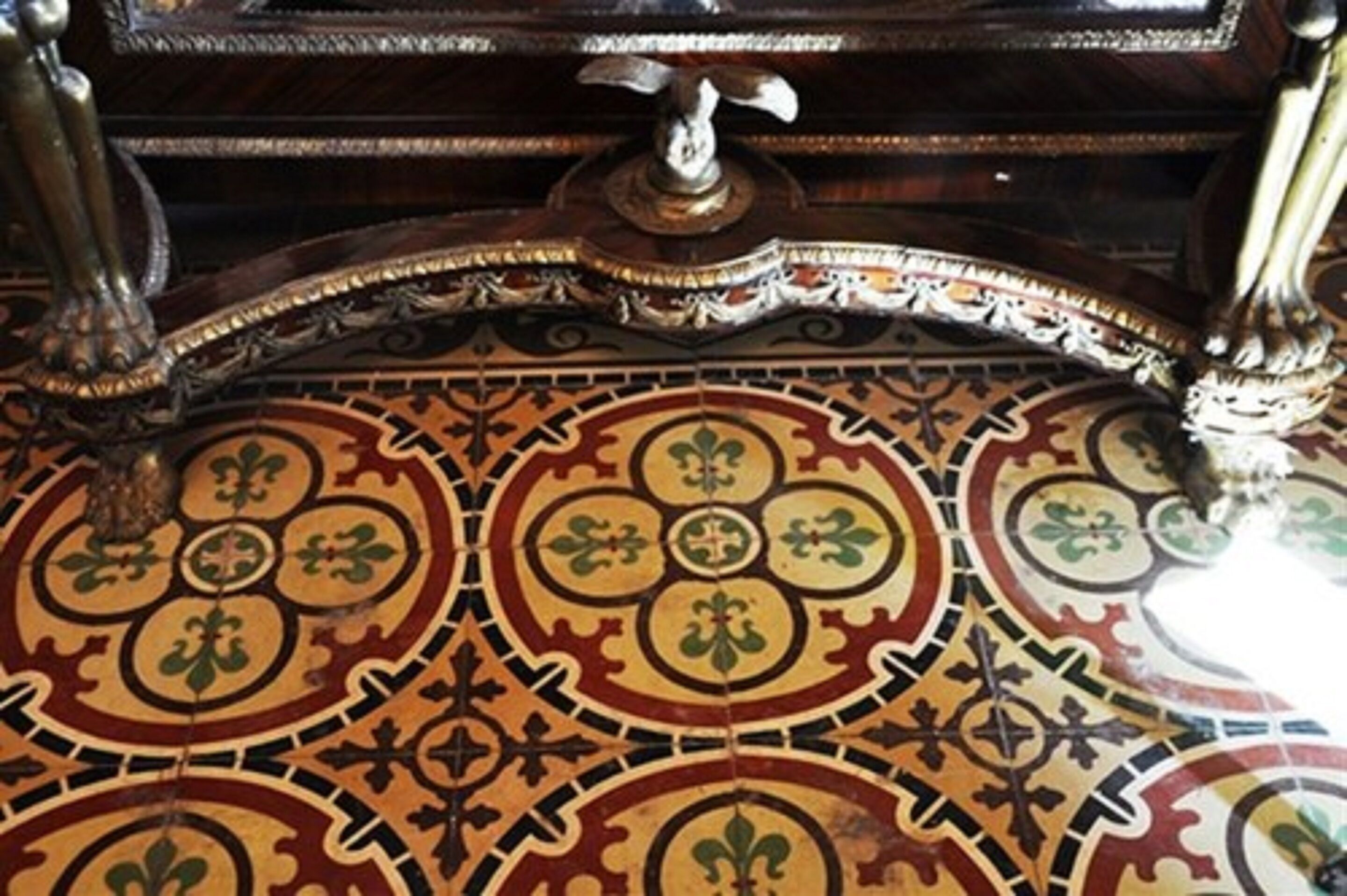A detailed tiled floor with a geometric pattern.