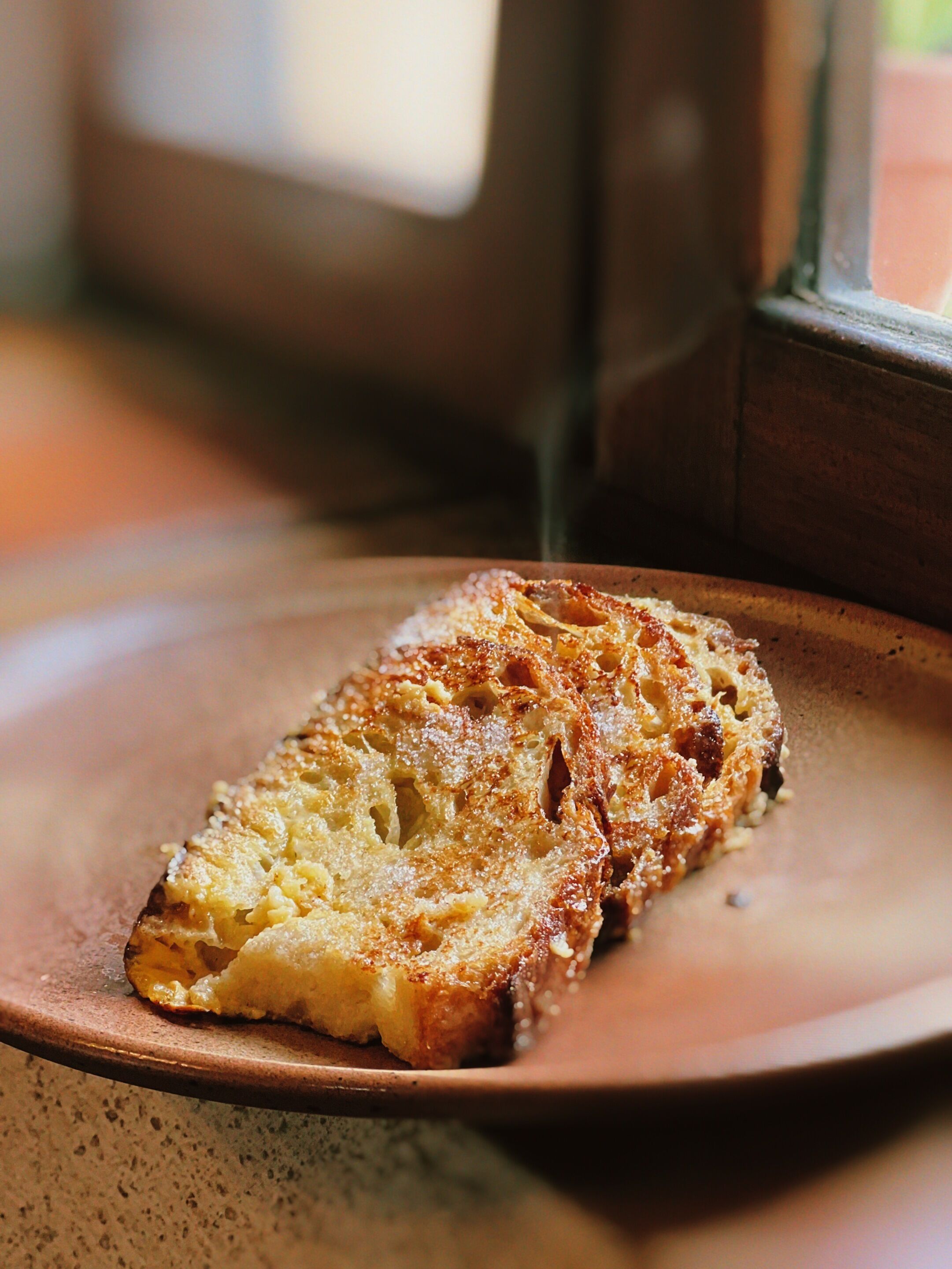 A slice of bread on a ceramic plate.
