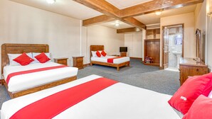 A hotel room with two beds, wooden headboards, and a bathroom with a sink and mirror. - Hotel Esperanza Oaxaca Centro (Oaxaca)