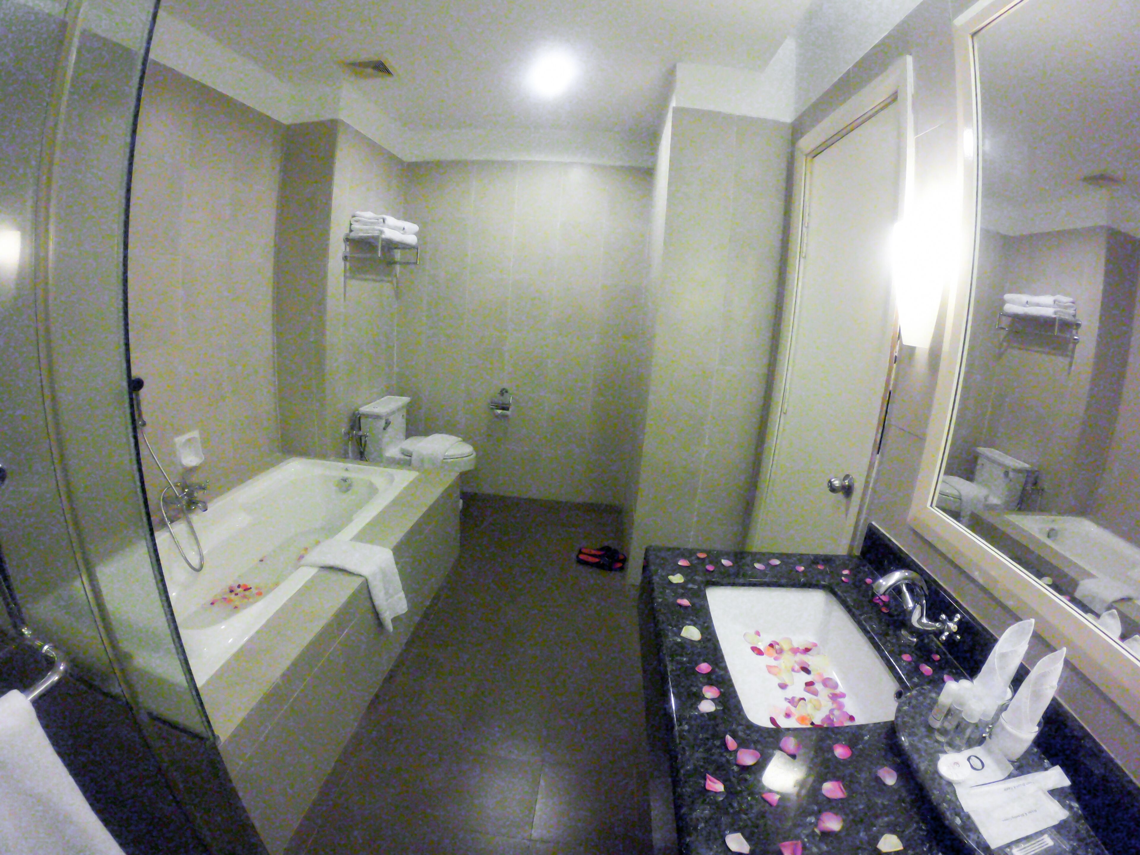 A bathroom with a bathtub, toilet, and sink.