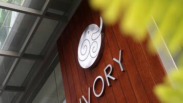 A sign with the word "IVORY" on a wooden wall, indicating the name of the establishment.
