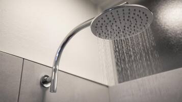 A modern showerhead with water flowing from it.