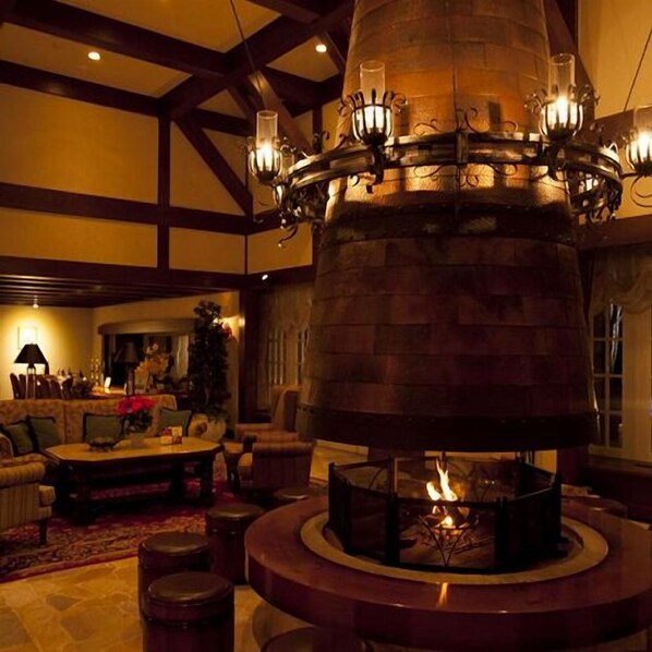 A cozy living room with a fireplace, wooden beams, and a fireplace surround. - Sun Members Hirugano (Gujo)