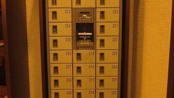 A hotel room key card slot with numbered room keys.