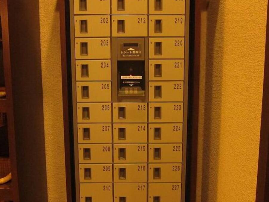 A hotel room key card slot with numbered room keys.