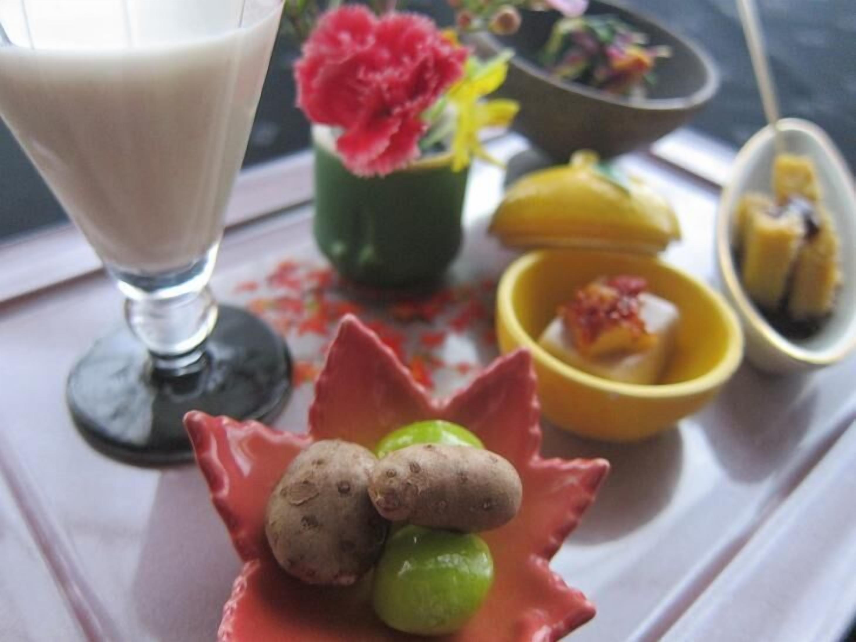 A dessert tray with a variety of sweets and a glass of milk.