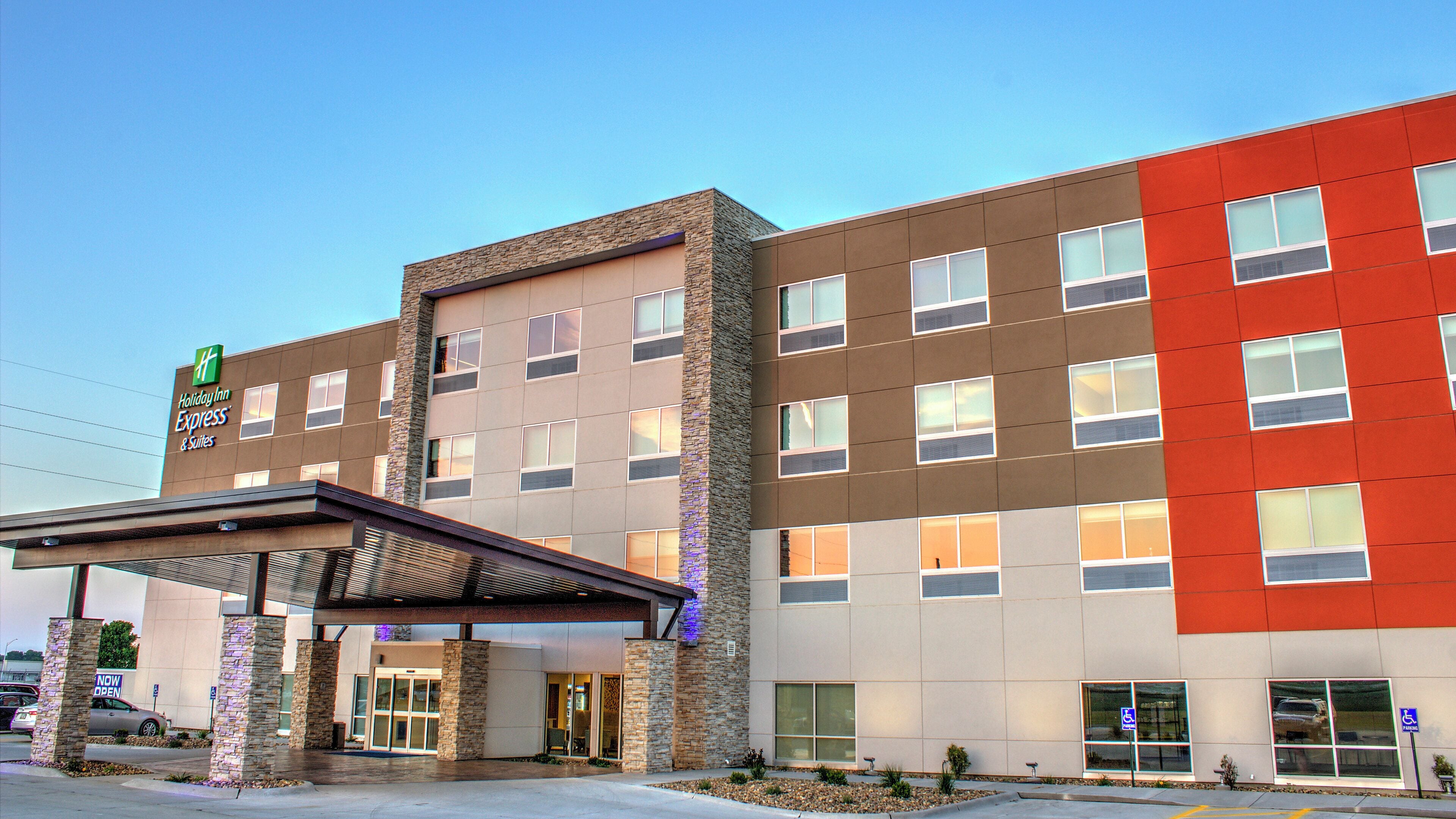 A Holiday Inn Express building with a stone facade, multiple windows, and a covered entrance.