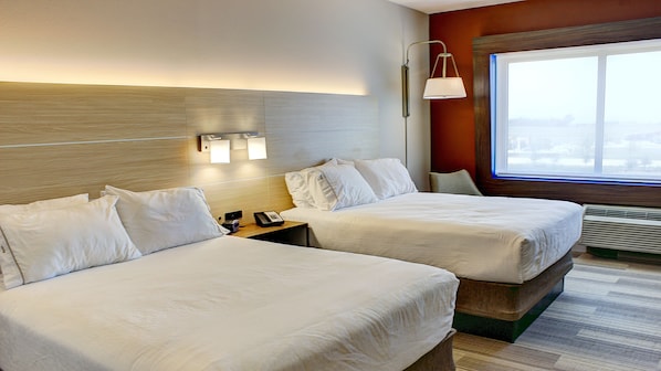 A hotel room with two beds, a nightstand with a phone, wall-mounted lights, and a large window with a view. - Holiday Inn Express & Suites Spencer by IHG (Spencer)