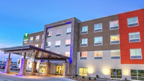 A Holiday Inn Express hotel with a modern facade, multiple windows, and a covered entrance area. - Holiday Inn Express & Suites Spencer by IHG (Spencer)