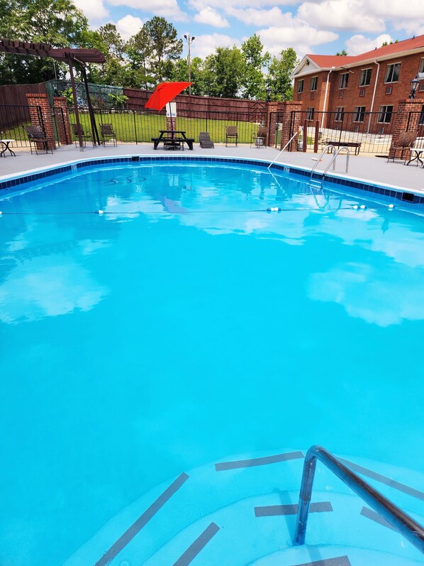 Seasonal outdoor pool, open 9 AM to 9 PM, pool umbrellas, pool loungers
