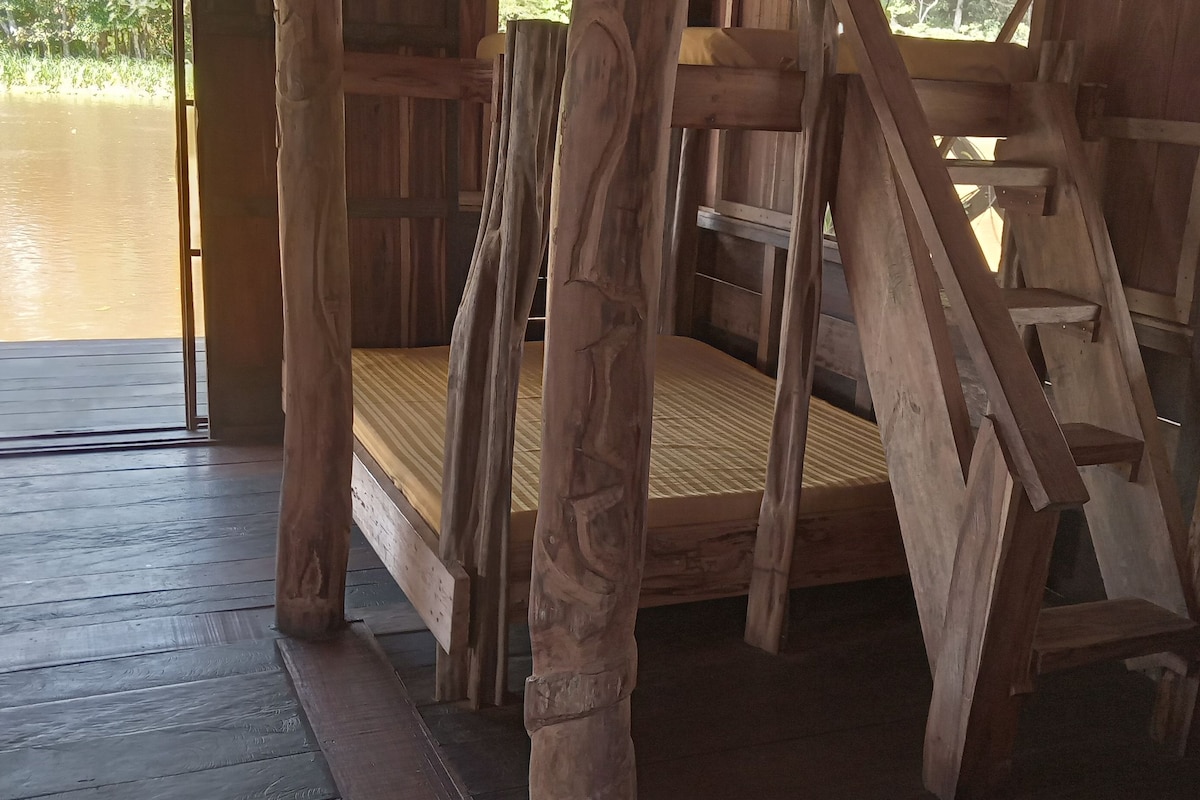 A wooden cabin with a view of a body of water.