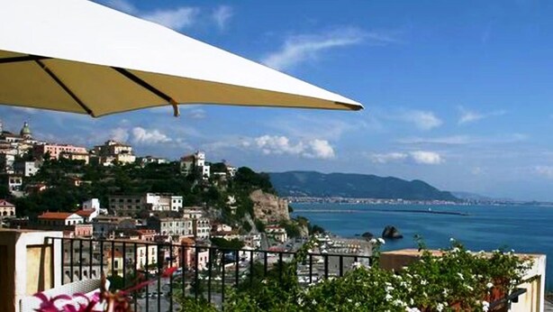 A coastal cityscape with buildings on a hillside overlooking the sea. - Palazzo Suriano Amalfi Coast (Vietri sul Mare)