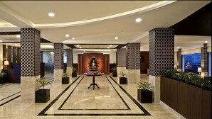 A hotel lobby with a central statue, patterned columns, and a reception desk. - Fortune Park Moksha, Mcleodganj  - Member ITC Hotels' Group (Dharamshala)
